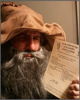 Hunter Davis dressed as a wizard, holding a copy of "Wandering Wizards Welcome (By Appointment)."